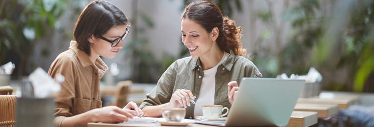 Two women are seen having an intense discussion at an open coffee shop.